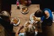 © L?a Jones/Stocksy - four kids eating together