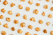 © Ilya/Stocksy - Popcorn kernels on white background
