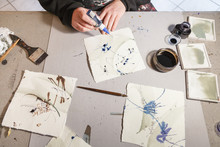 A Calligrapher Creating Artworks In His Workshop