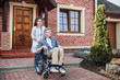 © Тарас Нагирняк - Friendly doctor caring about elderly disabled man in wheelchair and walking with him!
