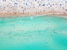 Bondi Beach Aerial View On A Perfect Summer Day With People Swimming And Sunbathing. Bondi Is One Of Sydney’s Busiest Beaches And Is Located On The East Coast Of Australia