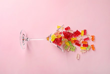 Martini Glass With Delicious Color Jelly Bears On Color Background, Top View