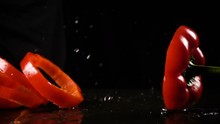 Falling Red Paprika Cuts With Water Splash, Slow Motion