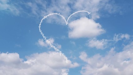airplane draws heart shape on the sky
