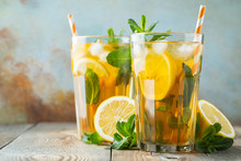 Traditional Iced Tea With Lemon And Ice In Tall Glasses On A Wooden Rustic Table