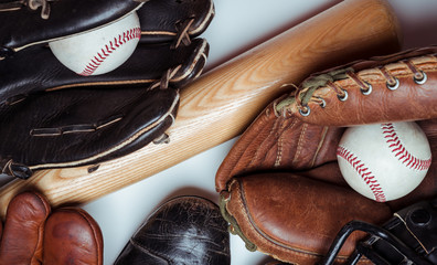 A group of vintage baseball equipment on a white background