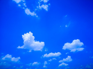 deep blue sky and white cloud background.