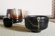 © riyat - Kintsugi Black Raku Tea Bowl with Gold Repair in Japanese Tea Ceremony Room