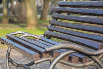 Photo of a bench in the park close-up