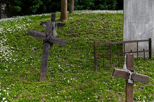 Gravestone Cross Made Of Wood On Green Grass.