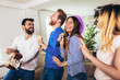 © Mediteraneo - Group of friends playing karaoke at home. Concept about friendship, home entertainment and people