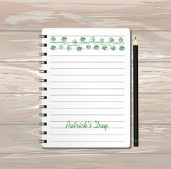 Notebook with template hand-drawn Green festive bunting with clover and pencil. Irish holiday - Happy St. Patrick's Day with a garland of three-leaf. Greeting card on holiday. Vector on wooden backgro