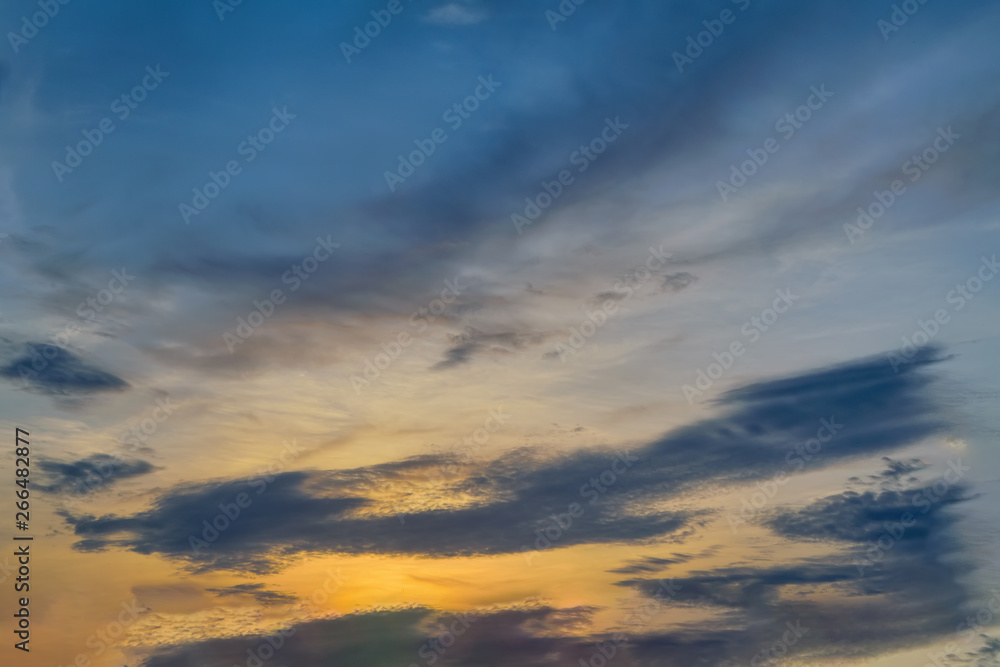 Blue sky with gold clouds - dramatic sunset, beautiful natural background. Setting sun illuminates the clouds. - obrazy, fototapety, plakaty 