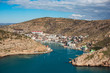 Aerial panoramic view of Balaklava bay in Crimea, mountain cliffs and sea with ships. Beautiful nature panorama landscape, town among hills and black sea coast from air