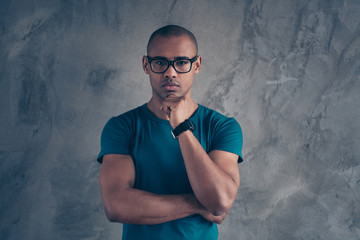 Wall Mural - Close-up portrait of his he nice lovely attractive muscular good-looking well-groomed masculine guy wearing blue t-shirt modern digital watch isolated over gray industrial concrete wall