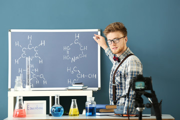 Wall Mural - Young male blogger recording video in laboratory