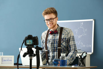 Canvas Print - Young male blogger recording video in laboratory