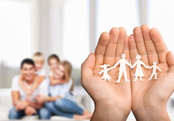 Poster - Love and relationships concept - closeup of man's cupped hands showing paper  family