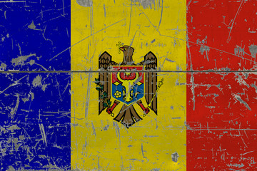 Grunge Moldova flag on old scratched wooden surface. National vintage background.