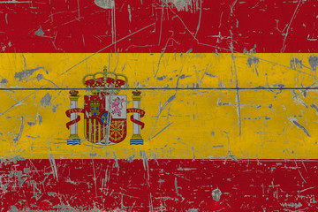 Grunge Spain flag on old scratched wooden surface. National vintage background.