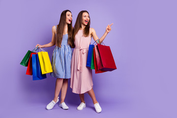 Poster - Full length body size photo two people beautiful she her models chic ladies carry many packs direct empty space laugh laughter fellowship wear casual dresses isolated purple violet bright background