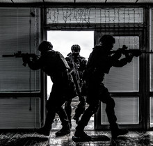 SWAT Team Breaching Door And Storming Apartments