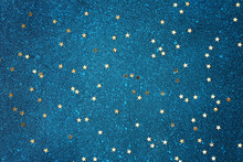 Confetti In The Form Of Gold Stars On A Blue Background. Starry Blue Sky Background.