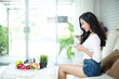 © potowizard - Young beautiful woman using a laptop computer at home.