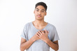 © Oleksandr - Portrait grateful happy black man holding hands on chest feeling pleased thankful.  African male expressing heartfelt appreciation gratitude honesty isolated on white studio background. Thanksgiving.