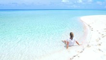 Slow Motion: Woman Sunbathing Relaxing In Turquoise Water White Sand Beach Tropical Sea Desert Island Wakatobi Indonesia Paradise Travel Destination Sunny Hot Day