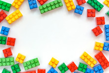 Educational Toys For Kids Mockup, Top View. Colorful Plastic Lego Blocks On White Background. Copy Space. Concept Of Education, Children's Creativity