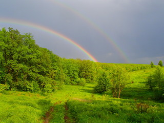 two rainbows after a rain on a summer day