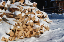 Firewood. Fresh Morning In The Snowy Mountains At A Ski Resort. Snow-covered Wooden Houses