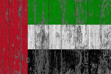 Flag of United Arab Emirates painted on worn out wooden texture background.