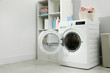 © New Africa - Modern washing machine in laundry room interior. Space for design