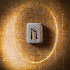 Canvas Print - Uraz. Handmade scandinavian wooden runes on a wooden vintage background in a circle of light. Concept of fortune telling and prediction of the future.