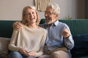 Wall Mural - Portrait of middle aged laughing man and woman at home