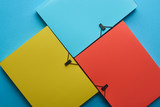 Fototapeta Paryż - top view of arranged colorful paper folders on blue