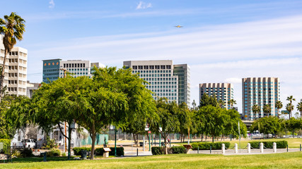 San Jose's downtown skyline as seen from the shoreline of Guadalupe River Park on a sunny spring day; Silicon Valley, California