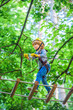 © Volodymyr - Small boy enjoy childhood years. Safe Climbing extreme sport with helmet. Child concept. Happy child climbing in the trees.