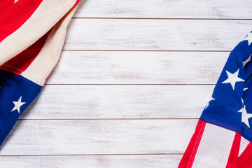 A set of American flags on a white slat wood background with copy space