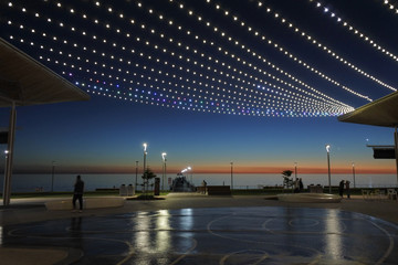 Wall Mural - ADELAIDE - MAY 06 2019:Silhouette of Henley Beach pier and square at dusk. Henley Beach pier is a very popular tourist attraction and sightseeing in Adelaide the capital city of South Australia. a