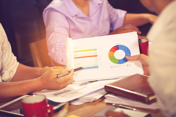 Financial advisor, accounting and Investment concept, business owners consult adviser financial meeting to analyze and on the finance report in the his office room.vintage color