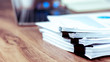 © JaRiRiyawat - Stack of documents placed on a business desk in a business office.