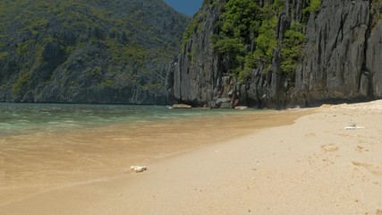 Wall Mural - Seascape ocean and beautiful beach, rocks on sandy beach with blue sea waves on sunny day, Palawan, Philippines
