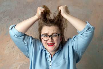 Wall Mural - Portrait of attractive plus size woman having anger emotions, expressing hopelessness and irritation isolated over colored background.  Stout woman shouting with rage. Concept of emotions.