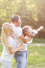 Wall Mural - happy family having fun outdoors