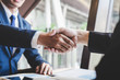 © Ngampol - Handshake of two business people after contract agreement to become partner