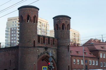 ancient gates to the city on the background of modern buildings