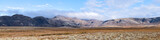 Fototapeta Tęcza - Landscape panoramic panorama view of Laugarvatn mountains with clouds covering on golden circle in Iceland during day and blue color sky in autumn